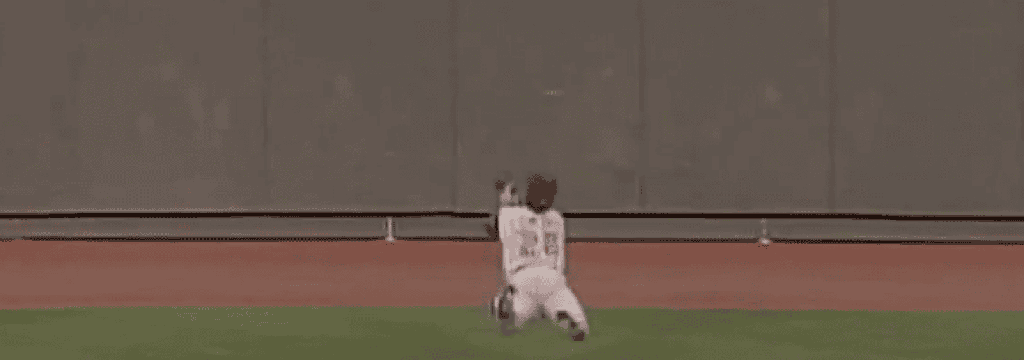 Jim Edmonds making a spectacular catch, showcasing his defensive skills as a centerfielder.